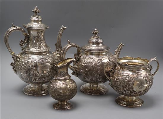A late Victorian ornate embossed silver three piece tea & coffee set, comprising, two pots and sugar bowl,